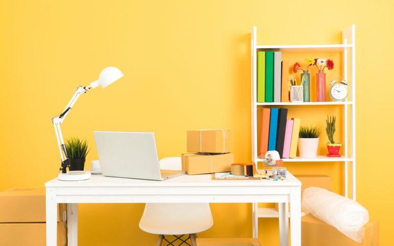business owner working at home office packaging on background.