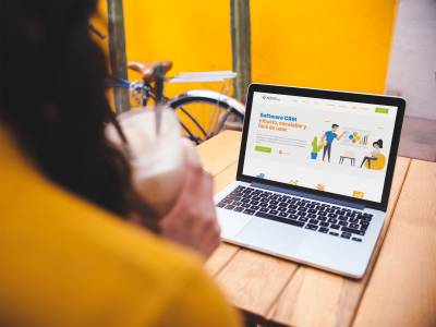 over-shoulder-mockup-of-a-woman-using-a-macbook-on-a-wooden-table-a19521 (1)